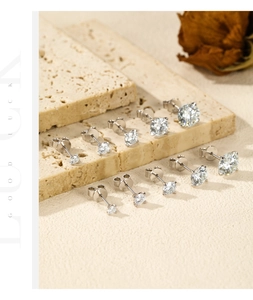 Detailed view of 5 pairs of S925 sterling silver moissanite stud earrings in varying sizes