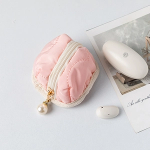 Detail of pink quilted cotton storage pouch with gold pearl zipper and diamond stitching
