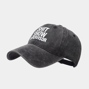 Detailed close-up of washed cotton baseball cap texture and vintage slogan print