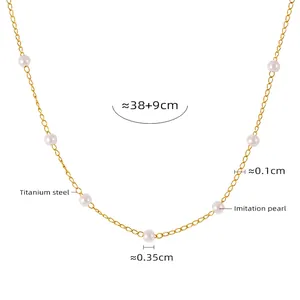 Detail of elegant gold titanium steel necklace featuring small 0.35cm white pearl accents