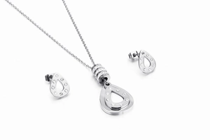 Detail shot of silver teardrop pendant necklace and stud earrings set with clear crystals