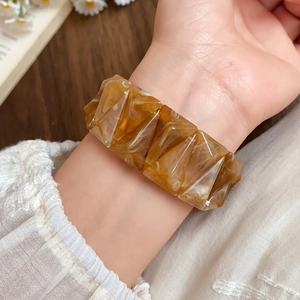 Macro detail of amber acrylic geometric bracelet showing texture and vintage tortoiseshell finish