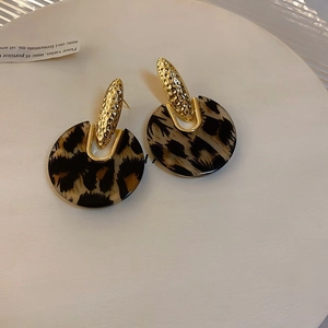 Detailed view of French vintage leopard print acrylic earrings with gold metal accents