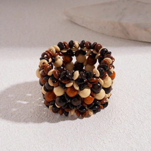 Detail of bohemian multilayer wooden bead bracelet featuring dark brown and red tones