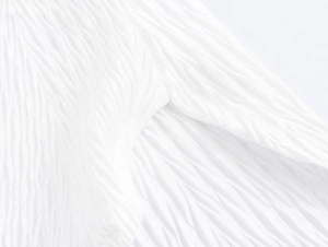 Detailed macro shot showing the textured white fabric with unique wrinkled patterns