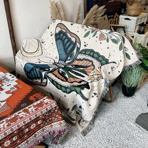 Bohemian woven cotton blanket featuring colorful butterflies and decorative fringe