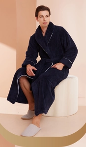 Detailed close-up of navy plush bathrobe showing thick flannel fabric and white piping