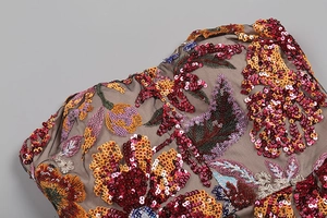 Detailed macro view of taupe mesh fabric with sequins and floral embroidery for dress
