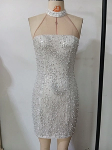 Detail of white bodycon dress featuring vertical silver sequins and pearl embellishments