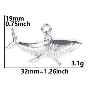 Macro detail of a 32mm stainless steel shark pendant with precise dimension markings