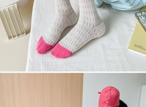 Close-up of white mesh hollow pattern socks with pink toes in casual home setting