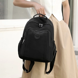 Minimalist black nylon backpack with high capacity and three-tier zipper compartments