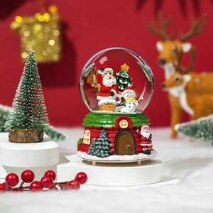 Musical Christmas snow globe with Santa and snowman on decorative cottage base