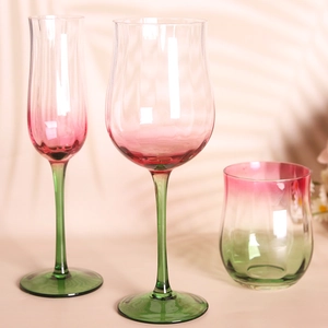 Vintage hand-blown wine glasses with pink and green gradient ribbed texture