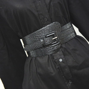 Fashionable black crocodile-patterned corset belt with square buckle over a black shirt