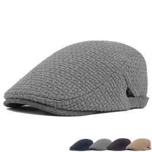 Detail view of the thick knit texture and adjustable metal buckle on the wool plaid beret