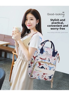 Fashionable gray diaper backpack with horse print shown in a casual lifestyle setting