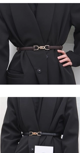 Detail view of thin black and brown leather belts with gold metal buckle on female waist