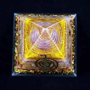 8cm Orgonite Pyramid with pink crystal, gold foil and copper coil on black background