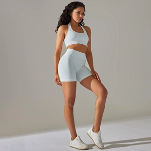 Detail of light blue seamless yoga set with ribbed knit texture and halter sports bra