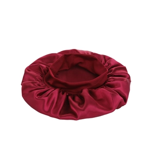 Detailed view of burgundy satin sleep cap fabric texture and elastic wide band