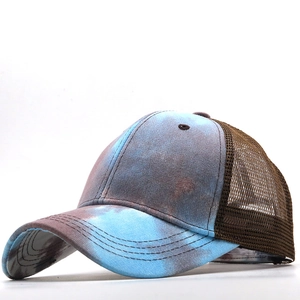 Detail of tie-dye baseball cap featuring breathable brown mesh and curved brim