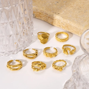 Set of gold titanium steel rings in geometric and floral petal designs on stones