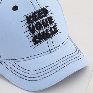 Light blue kids baseball cap featuring black Keep Your Smile embroidery and breathable mesh