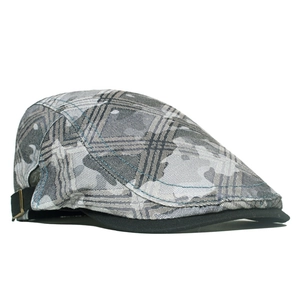 Detailed view of grey camouflage ivy cap featuring metal buckle and side strap