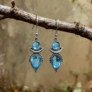 Bohemian blue moonstone drop earrings with silver crescent moon detail on branch