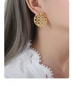 Side view of model wearing gold hollow woven round earrings in vintage style stainless steel