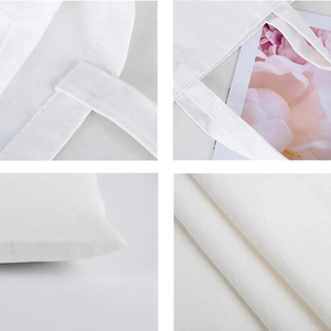 White canvas tote bag details showing handle stitching and durable fabric texture