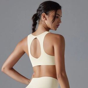 Close-up of the breathable circular back cutout design on this cream sports bra
