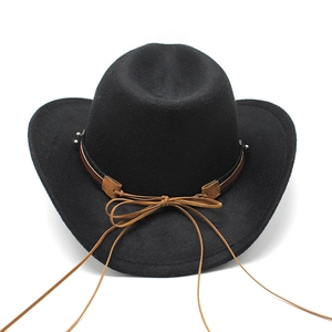 Detail of western cowboy felt hat featuring a brown leather band and suede bow decoration