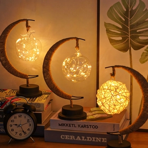 Detailed view of LED crescent moon lamps with jute rope and warm copper wire lights