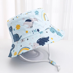 Detail of blue kids sun hat featuring dinosaur prints and adjustable white wind rope