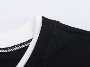 Close-up of contrast crew neck stitching on a casual black and white double-layer T-shirt