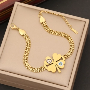 Golden clover bracelet with blue evil eye detail in a premium beige jewelry gift box