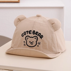 Close-up of cute bear embroidery and 3D ears on a breathable beige baby sun hat