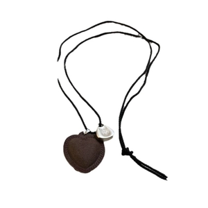 Brown leather heart pendant necklace with black braided cord and silver metal tag