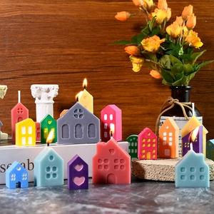 Detailed view of colorful miniature house candles with fine window and door carvings