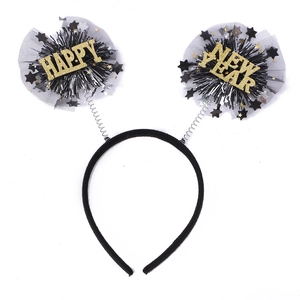 Detailed view of Happy New Year headband featuring black tassels and gold glitter text