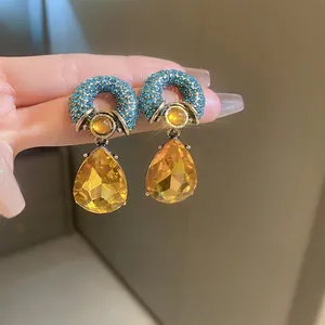 Vintage style drop earrings with blue crystal rings and yellow pear-shaped gemstones