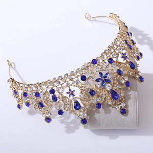 Detail of luxury gold bridal tiara with blue crystals and sparkling rhinestones