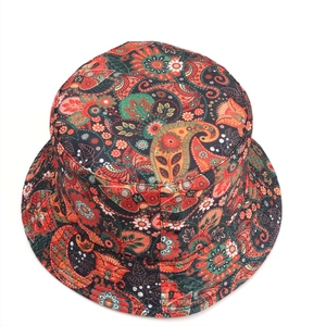 Close-up of a double-sided bucket hat with vibrant red paisley pattern and cotton texture