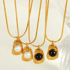 Irregular gold teardrop necklaces with pearl and black gemstone on snake chains