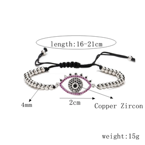 Detail of beaded evil eye bracelet showing copper beads and pink zircon eyelash pendant