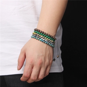 Detail shot of multilayered 6mm natural stone beads and wood bracelets on wrist