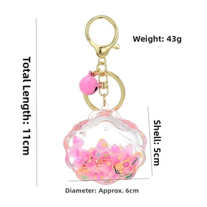 Pink shell keychain with dimensions showing 11cm length and internal glitter charms
