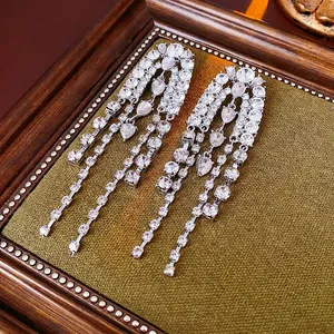 Elegant silver teardrop tassel earrings with sparkling rhinestones in a luxury display